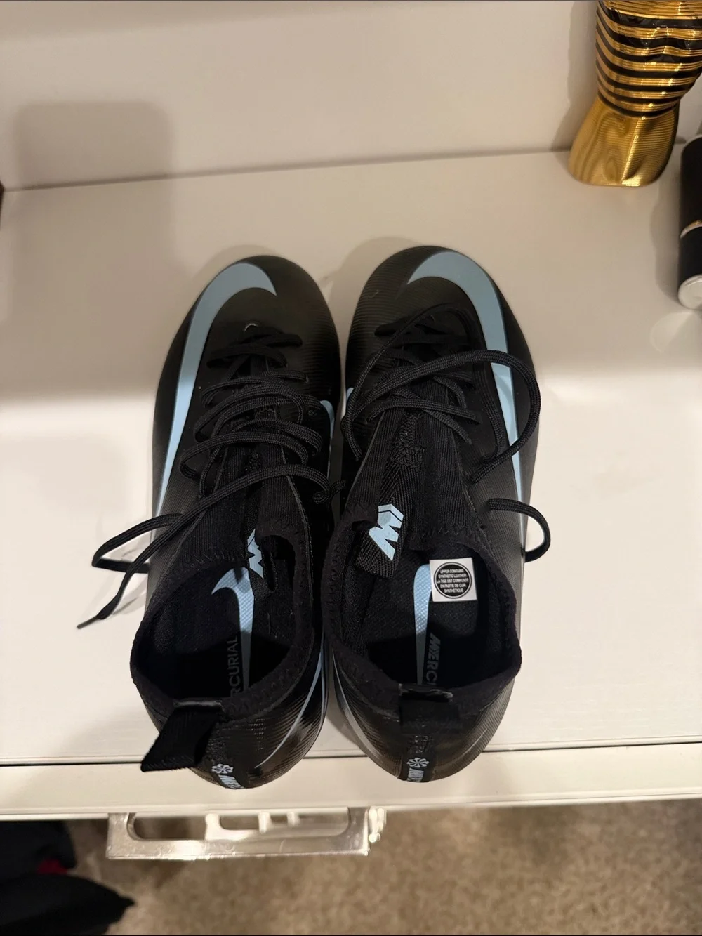 Nike Men’s Black Athletic Cleats with Light Blue Swoosh
